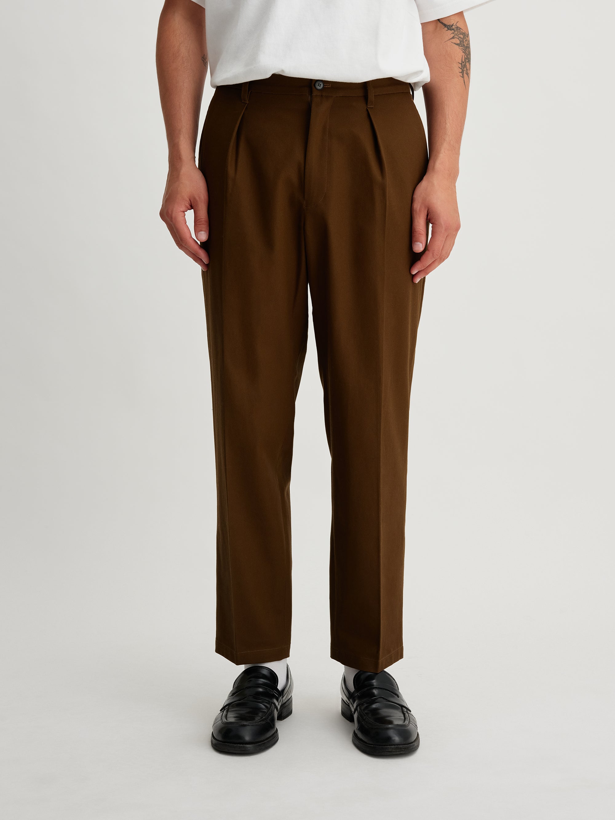 Saturdays NYC. 1Tuck Tapered Pants. Top view of model highlighting the waistband and high-twisted cotton fabric, in khaki.