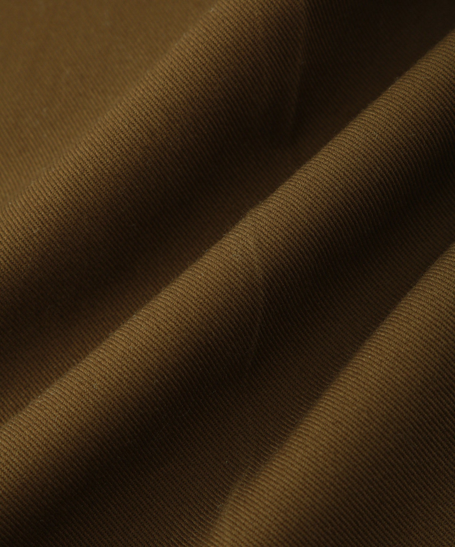 Saturdays NYC. 1Tuck Tapered Pants. Close-up of the high-twisted cotton fabric, showcasing the crisp texture and refined finish, in khaki.